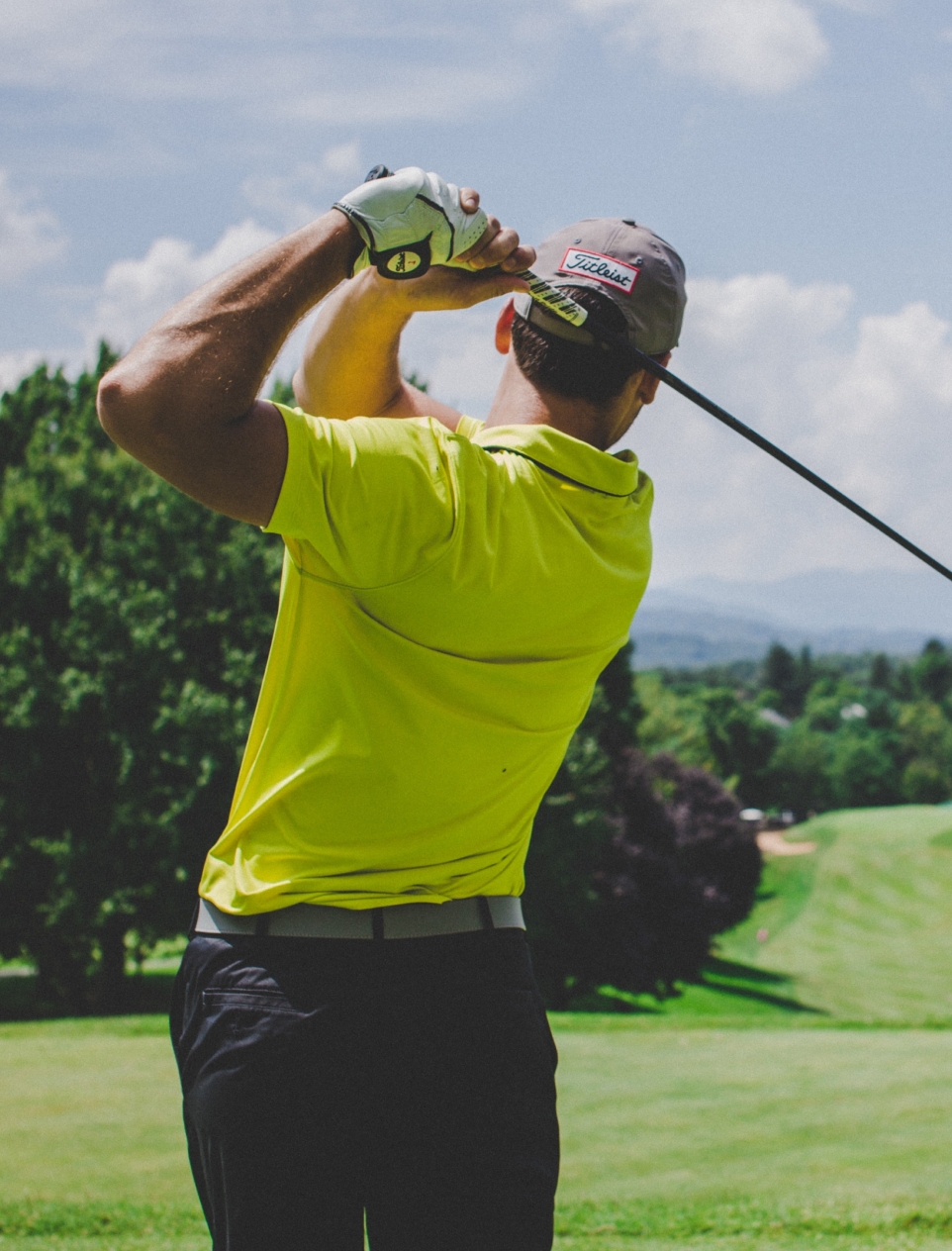 Golfer shooting golf ball